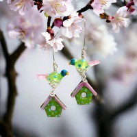 Playful and whimsical Earrings, consistant of a little glass bird and a bird house in spring colors