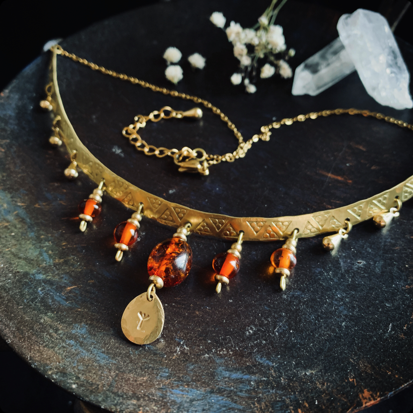 Antique necklace with polished amber and rune pendant