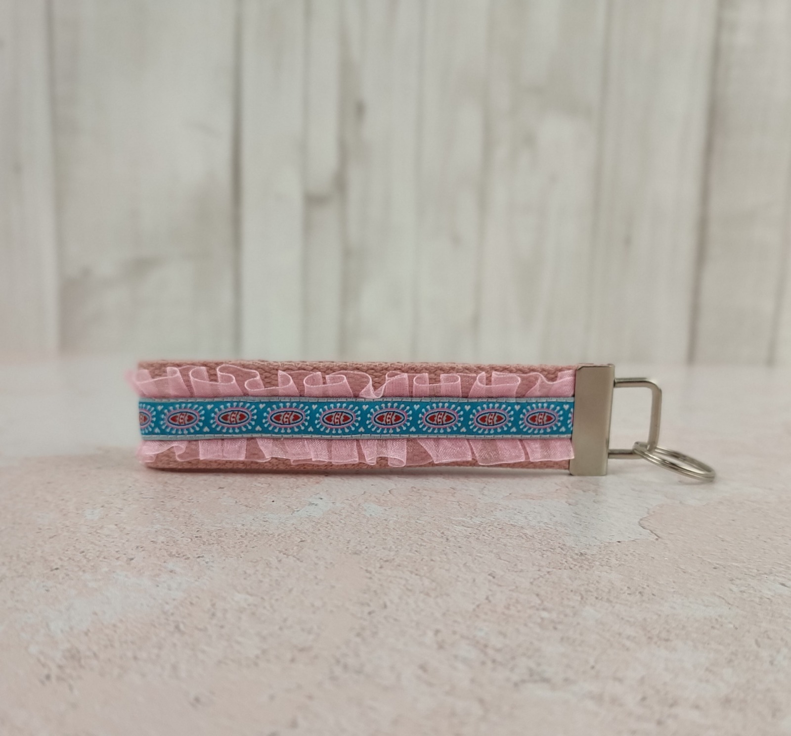 Kurzes Schlüsselband aus Gurtband in rosa - verziert mit Rüschen und Webband in petrol mit kleinen Herzchen