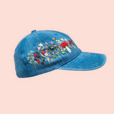 Baseball cap with hand-embroidered mushroom and wildflower