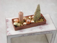 Rechteckige goldene Platte mit beiger Kerze in weihnachtlicher Dekoration
