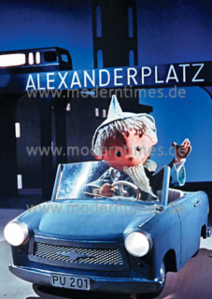 Postkarte A6 modern times Sandmännchen im Trabant am Alexanderplatz - Postkarte A6 105 x 148 cm